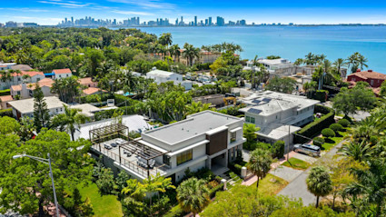 Aerial view of luxury vacation home with the Miami skyline in the background