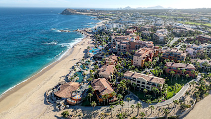 A stock photo shows a cluster of beachfront resorts in the Tourist Corridor.
