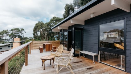 modern house with wood chairs on balcony