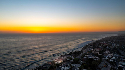 Coastal San Diego at sunset illustrates why terraces are ideal for year-round gatherings, with ocean views and temperate weather.