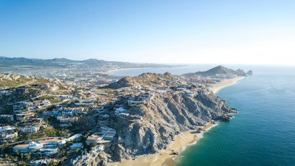 Aerial view of Cabo’s coastline highlights how neighborhoods place golfers close to marquee courses along the corridor.