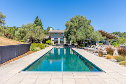 Sunlit pool and patio at Infinite Road, illustrating how Sonoma homeowners can enjoy the outdoor lifestyle and host guests during the festive harvest season.