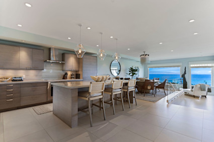 Gourmet kitchen and open living at Lani in Kapalua, an elegant setting near The Sentry at the Plantation Course and seasonal Maui events.