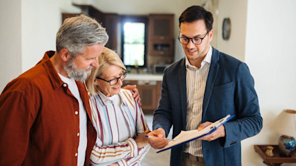 Couple reviewing home closing contract. 