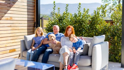 family sitting on outdoor couch
