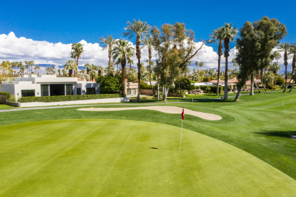 golf course with house in the background