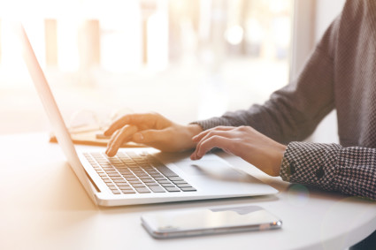 Woman conducting research on laptop computer