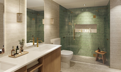 Elegant bathroom with sage green tile, gold fixtures, glass-enclosed walk-in shower, and warm wood vanity.