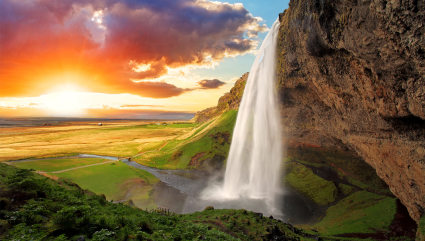 A large waterfall fills a remote pool near Reykjavik, one of the best vacation spots for couples. 