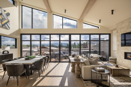 Luxury living room area with floor to ceiling windows.