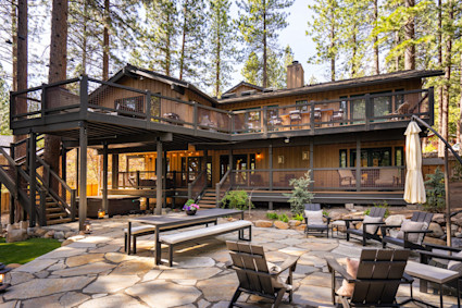 Wood Creek in Incline Village features a wraparound deck amid towering pines, ideal for soaking in Lake Tahoe's spring mountain and forest views.