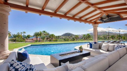 Spacious outdoor living area with couches and a pool