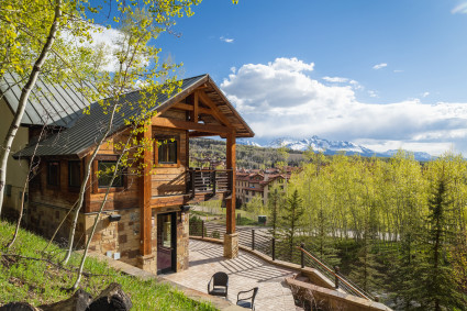 large, luxury ski cabin surrounded by trees