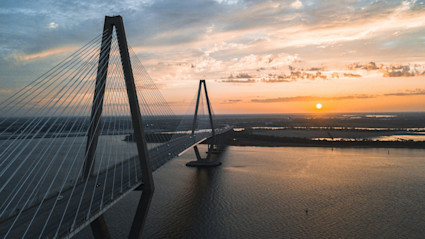 A sunset over the Ravenel Bridge mirrors the citys evening energy during Halloween weekend.