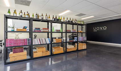Interior of the wine cellar at Uovo wine with bookcases with books and wine bottles on them. 