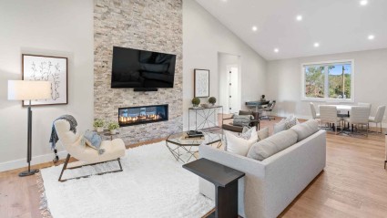 A contemporary living room featuring a stone fireplace, adding a touch of elegance and warmth to the space