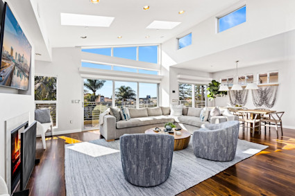 The living room at Sail Bay offers a sophisticated, sunlit space for gathering friends and family in style—ideal for race day celebrations or relaxing between events.
