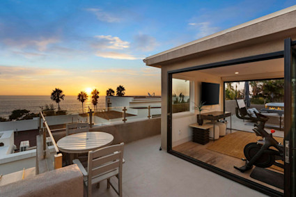Windansea in La Jolla showcases a rooftop outdoor kitchen and dining area designed for coastal entertaining with panoramic views.