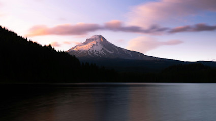 View of Hood mountain as seen from a lake with purple sunset.