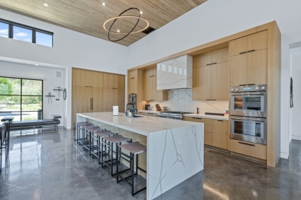 An image depicts the kitchen of a home that has incorporated a number of luxury interior design principles. 