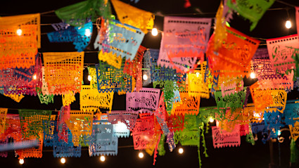 A stock photo shows colorful lights in downtown Cabo.