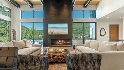 Living room with floor-to-ceiling windows and mountain views