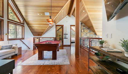 A rustic room with a pool table.