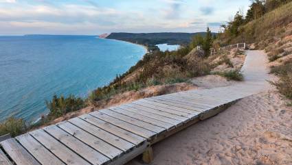 A wooden pathway follows the coast of Sleeping Bear Dunes National Park,  one of the best beaches for kids in the Midwest. 