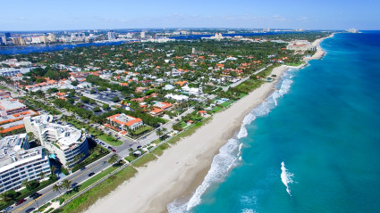 Aerial view of a long beach in front of a town