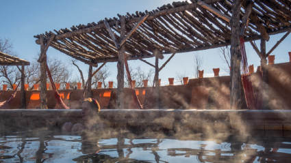 A photo of people relaxing in a hot spring, one of the many empty nest ideas to try.