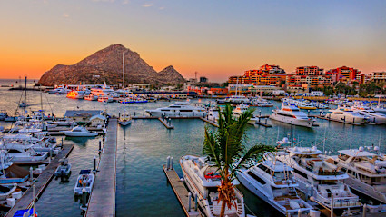 A photo shows boats floating in the harbor of Cabo San Lucas.
