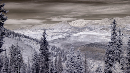 Snow-covered peaks and frosted evergreens in Telluride, Colorado, evoke the magic of winter and set the tone for the highly anticipated ski resort opening day. The tranquil landscape captures the seasonal transition perfectly, igniting excitement for winter sports and mountain adventures.