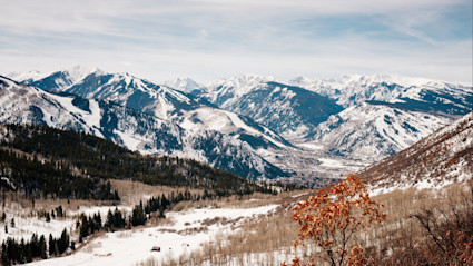 Snow capped mountains on a partly cloudy day