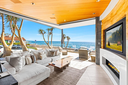A luxury home terrace in La Jolla, California, with a stunning ocean view and outdoor seating, designed for private entertaining and relaxation.