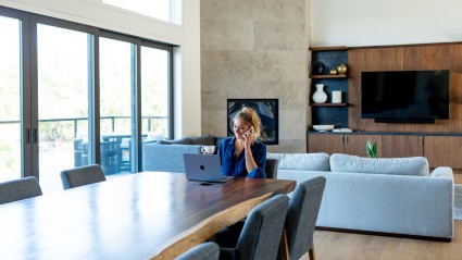 Woman working on her laptop in her remote home office