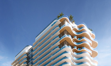Luxury tower with undulating white wave-form balconies, wood accents, glass railings, and rooftop palms against blue sky.