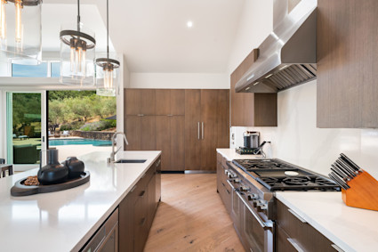 The kitchen at Grove in Napa showcases the pinnacle of luxury kitchen design, including a 10-foot island, handmade cabinetry, high-end appliances, and entertainment-ready dining space. This functional and elegant kitchen is ideal for home chefs and hosts.