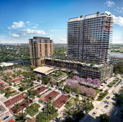 Aerial view of a luxury mixed-use development with two modern high-rise towers, tennis and pickleball courts, flowering trees, and a landscaped amenity deck.