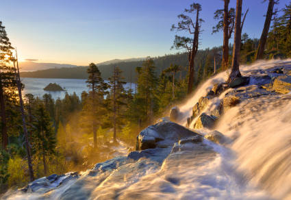 A waterfall cascading with Lake Tahoe on the horizon.