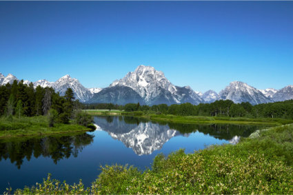 A photo shows the backdrop of Wyoming mountain getaways, the Grand Tetons.