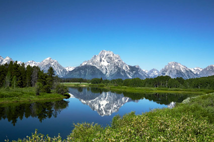 A photo shows the backdrop of Wyoming mountain getaways, the Grand Tetons.