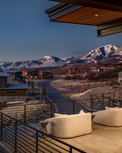 Upper deck with curved white lounge seating and Deer Valley peaks at dusk, mobile crop, Deer Peak listing