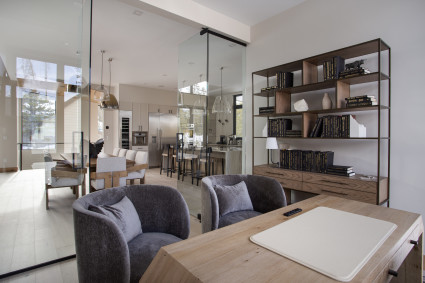 Inside of a Breckenridge vacation home with a warm ambiance, featuring comfortable furniture, tasteful decor, and ample natural light