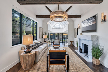 A refined living room with fireplace in Madrona, echoing the warmth and comfort guests experience at intimate Sonoma gatherings during harvest season.