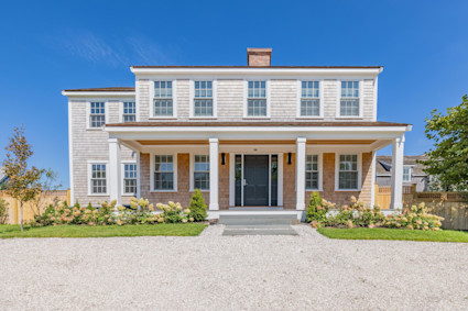 front view of a charming Nantucket home with a manicured yard, offering a welcoming introduction to the island's classic architecture and ambiance during the Nantucket Film Festival season