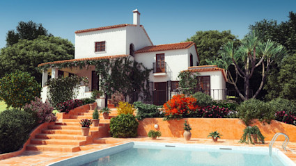 A beautiful villa with a pool and lush garden, suggesting a higher average vacation cost for a luxury trip.