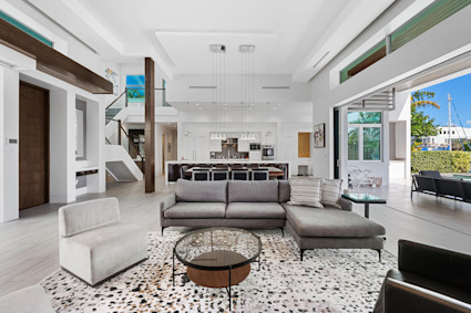 Las Olas near Miami features a high ceiling great room that connects to the pool deck, creating an ideal setting for game tables and lively hosting.
