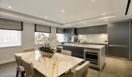 A modern kitchen with marble kitchen table.