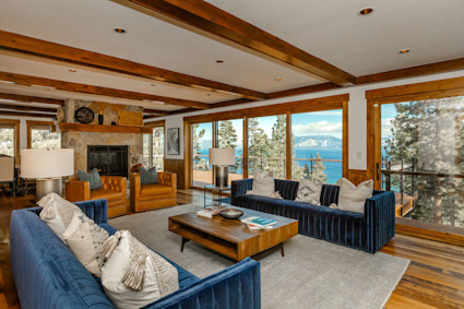 Lakeridge's beam ceiling and glass doors frame lake and mountain views while enhancing warm, social interiors.