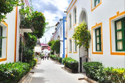 a street with white buildings and trees